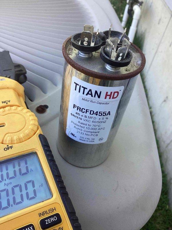 Responded to no cooling complaint on 2011 residential air conditioning system. Upon arrival, confirmed unit was running but not cooling the home adequately. Performed diagnostic testing on outdoor condensing unit and identified failed run capacitor using digital multimeter. Measured capacitance and amperage readings which confirmed capacitor was out of specification and preventing compressor from operating efficiently. Replaced defective capacitor with new TITAN HD motor run capacitor (model PRCFD455A), verified proper electrical connections, and tested system operation. Unit restored to normal cooling operation with all components functioning within manufacturer specifications.