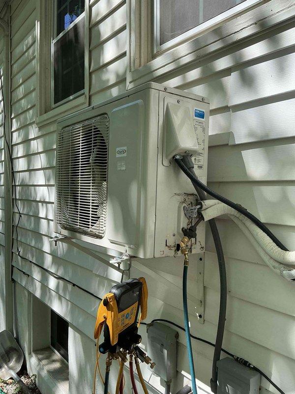 Responded to service call for 6-year-old attic-mounted mini split system reported as turning on but not producing cold air. Performed diagnostic testing using manifold gauges to assess refrigerant pressures and system performance. Inspection revealed corrosion and oxidation at electrical junction box connections and service port fittings. Addressed connection issues at outdoor unit, including corroded terminals and compromised electrical connections. Tested system operation following repairs and verified proper cooling functionality restored to unit.