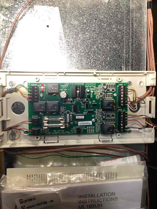 Responded to no cooling call on 10+ year old unit located on right side of home. Upon arrival, diagnosed failed compressor preventing system operation. Accessed control board assembly and documented existing electronic control components including circuit board with multiple relays, 24VAC transformer connections, and associated wiring. Inspected heat exchanger, copper refrigerant lines, and electrical connections to control board. Photographed control board model ML193UH with Lenox Industries components showing circuit layout, relay positions, and wiring configuration for service documentation and potential replacement parts identification.