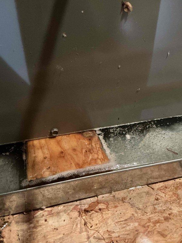 Responded to scheduled service call for HVAC system. Upon arrival, documented existing conditions including condensate drainage system with PVC piping and union fitting, drip pan with standing water accumulation, and evidence of moisture intrusion along foundation perimeter showing black mold growth on subflooring and metal trim junction. Job was cancelled after dispatch and equipment arrival, with photographic documentation completed prior to departure.