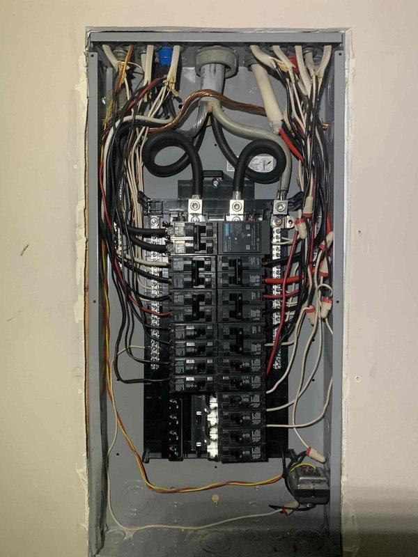 Completed installation of new residential electrical service panel with integrated surge protection device. Installed modern circuit breaker panel with dual-column breaker configuration, properly terminated all branch circuit conductors, and established main service connections at the bus bar. All existing circuits were systematically transferred to the new panel, with wiring color-coded and routed appropriately through the enclosure. Surge protection was integrated into the system to safeguard against voltage spikes and electrical surges.