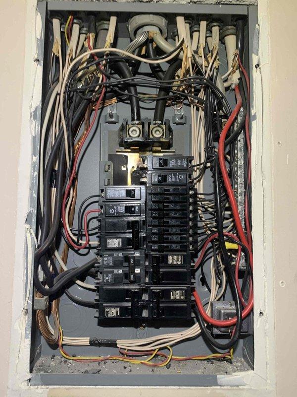Completed installation of new residential electrical service panel with integrated surge protection device. Installed modern circuit breaker panel with dual-column breaker configuration, properly terminated all branch circuit conductors, and established main service connections at the bus bar. All existing circuits were systematically transferred to the new panel, with wiring color-coded and routed appropriately through the enclosure. Surge protection was integrated into the system to safeguard against voltage spikes and electrical surges.