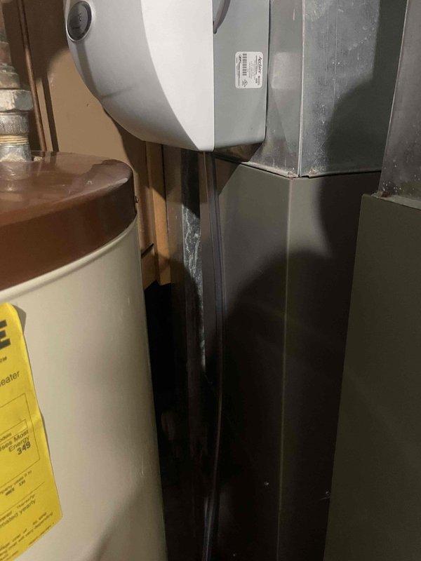 Responded to callback regarding contaminated tubing between HVAC units and Aprilaire humidifiers that had accumulated soot and mold buildup, which had been previously overlooked during prior service visits. Replaced all affected drain hoses connecting the dual Lennox units to their respective humidification systems, ensuring proper drainage and eliminating contamination hazard.