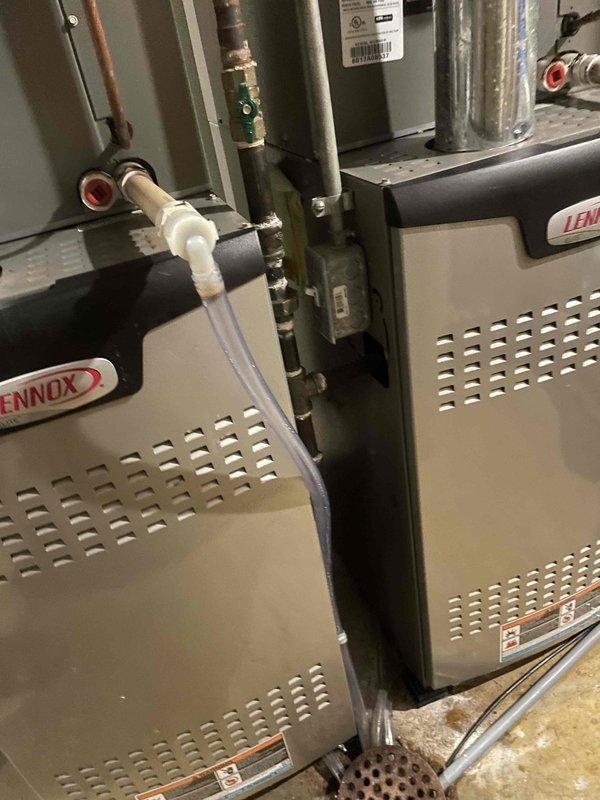 Responded to callback regarding contaminated tubing between HVAC units and Aprilaire humidifiers that had accumulated soot and mold buildup, which had been previously overlooked during prior service visits. Replaced all affected drain hoses connecting the dual Lennox units to their respective humidification systems, ensuring proper drainage and eliminating contamination hazard.