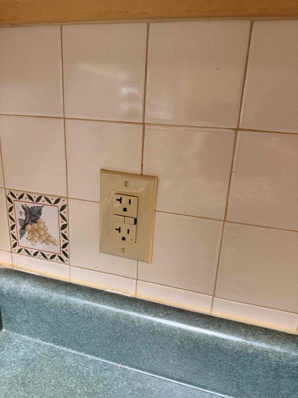 Responded to service call for non-functioning kitchen outlet with no power. Inspected electrical circuit breaker panel and identified tripped breaker controlling the affected kitchen circuit. Reset breaker and verified power restoration to the kitchen outlet. Tested receptacle for proper voltage and confirmed full functionality upon service completion.