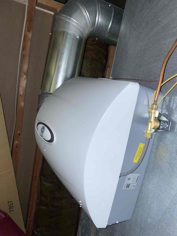 Installed AprilAire 600M whole-home humidifier unit to existing HVAC system. Connected unit to ductwork with galvanized metal transition elbow, mounted humidistat control on system cabinet, and established water supply line connection via brass valve fitting. System tested and confirmed operational with heating and cooling modes.