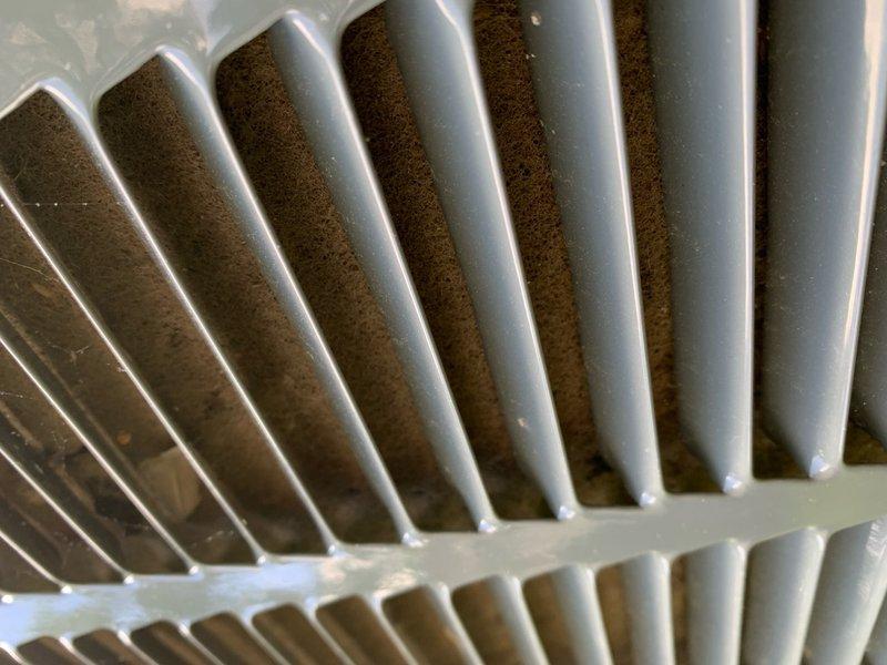 Completed comprehensive cooling system tune-up on 8-year-old raised AC unit located in basement area. Performed standard maintenance protocol including inspection of condenser coil fins, which showed moderate dust and debris accumulation between fins, and verified proper system operation. Unit access required navigating exterior basement stairwell with weathered concrete and metal railing system.