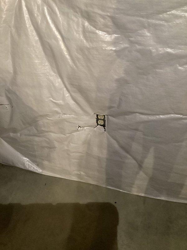 Responded to service call for non-functioning basement outlet and GFCI issues on 12-4 circuit breaker. Diagnosed faulty GFCI receptacle in basement area behind protective plastic sheeting and replaced defective outlet to restore proper electrical function and ground fault protection.