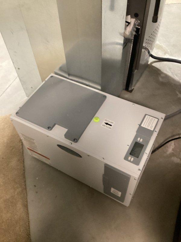 Completed installation of E80 whole-home dehumidification system in basement mechanical room. Unit was mounted on concrete floor adjacent to existing HVAC air handler, with all necessary ductwork connections, condensate drainage plumbing, and electrical wiring installed per manufacturer specifications. System was tested and verified operational with digital controls programmed and functioning properly.