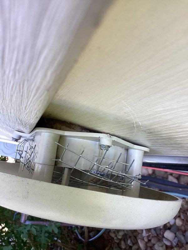 Installed protective wire screen guard over exterior HVAC vent opening to prevent birds from nesting inside the system. The screen cover was securely mounted to the underside of the outdoor structure overhang, ensuring proper airflow while blocking wildlife access to the ventilation system.