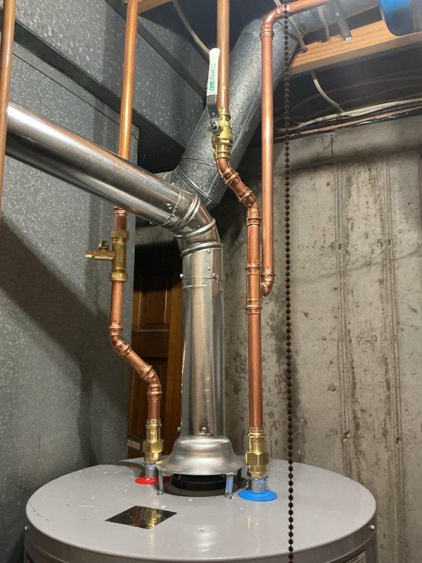 Installed 50-gallon tall gas water heater in residential mechanical room with complete copper supply and discharge piping, brass shutoff valves, and pressure relief valve connections. Applied required plumbing identification sticker and completed installation per permit #26plu-08138. Unit was coordinated for delivery to warehouse and transported to job site by HVAC team for final installation.