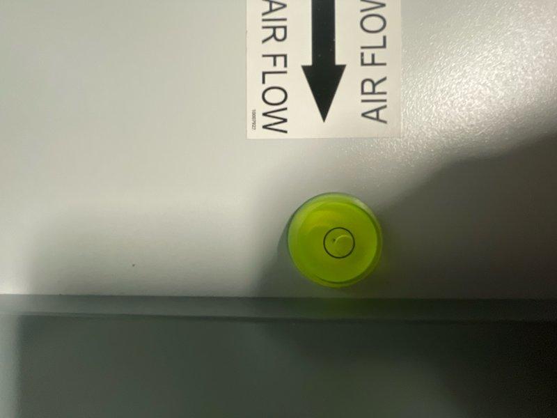 Responded to recall for newly installed dehumidifier experiencing abnormal blowing noise in basement. Inspected unit installation, verified proper airflow direction marking and leveling of equipment. Documented equipment positioning and alignment with photographic evidence showing unit level and airflow indicators functioning as designed.