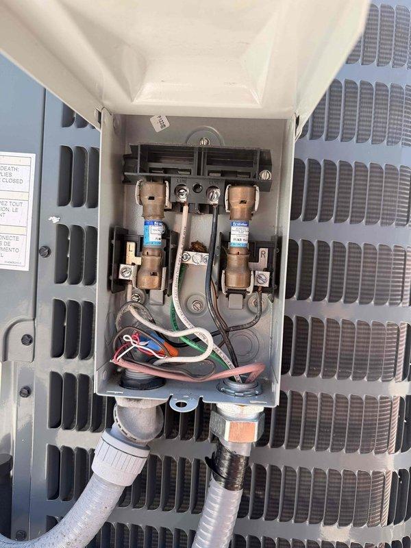 Installed two dedicated electrical circuits for HVAC equipment as per approved estimate. Work included running new wiring through structural framing, establishing proper electrical connections at junction points with appropriate insulation and protection, and completing all terminations at the outdoor unit's disconnect box. Installed cartridge fuses in disconnect enclosure and properly dressed all conductors including ground, line, and control wiring with secure connections through liquid-tight conduit fittings. All work performed to code with proper wire management and protection methods employed throughout the installation.