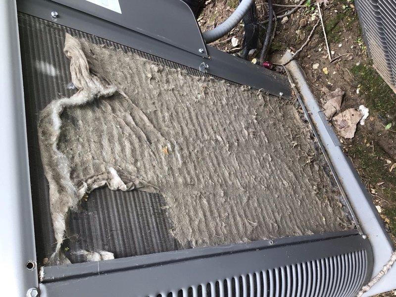 Performed diagnostic evaluation on three 10-year-old residential air conditioning units following reports of refrigerant leaks requiring system replacement. Conducted thorough refrigerant charge verification on all three systems. Inspection revealed outdoor condenser unit with severely restricted airflow due to heavy accumulation of dirt, dust, lint, and environmental debris coating condenser coils. Contamination was particularly dense on left side and center sections, creating thick matted layer obscuring coil fins and significantly reducing heat transfer efficiency. Documented indoor air filtration system equipped with 20x25 Allergen Plus electrostatic pleated filter in acceptable condition. Communicated findings for further assessment and recommendations regarding actual need for system replacement versus comprehensive cleaning and maintenance services.