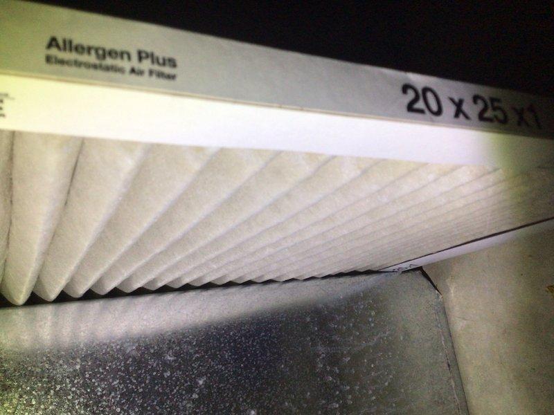 Performed diagnostic evaluation on three 10-year-old residential air conditioning units following reports of refrigerant leaks requiring system replacement. Conducted thorough refrigerant charge verification on all three systems. Inspection revealed outdoor condenser unit with severely restricted airflow due to heavy accumulation of dirt, dust, lint, and environmental debris coating condenser coils. Contamination was particularly dense on left side and center sections, creating thick matted layer obscuring coil fins and significantly reducing heat transfer efficiency. Documented indoor air filtration system equipped with 20x25 Allergen Plus electrostatic pleated filter in acceptable condition. Communicated findings for further assessment and recommendations regarding actual need for system replacement versus comprehensive cleaning and maintenance services.