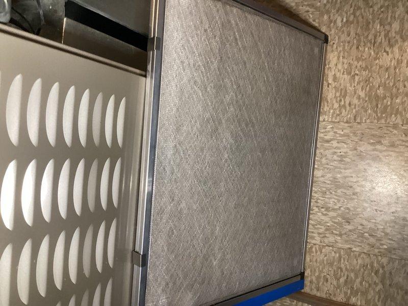 Completed comprehensive tune-up service on two 8-year-old air conditioning units located in raised basement installation. Performed full system inspection including filter examination, electrical diagnostics with digital multimeter, and condenser coil assessment. Both units showed normal operating parameters with clean filters in place and proper airflow through air handling components.