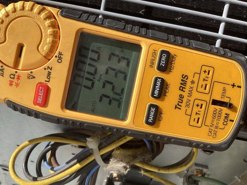 Completed comprehensive tune-up service on two 8-year-old air conditioning units located in raised basement installation. Performed full system inspection including filter examination, electrical diagnostics with digital multimeter, and condenser coil assessment. Both units showed normal operating parameters with clean filters in place and proper airflow through air handling components.