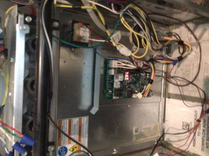 Completed comprehensive cooling tune-up on rooftop AC unit accessed through attic. Performed full system inspection including electrical connections, control board functionality, and blower motor components. System operating properly with normal condensation present on exterior panel, indicating effective cooling cycle performance.