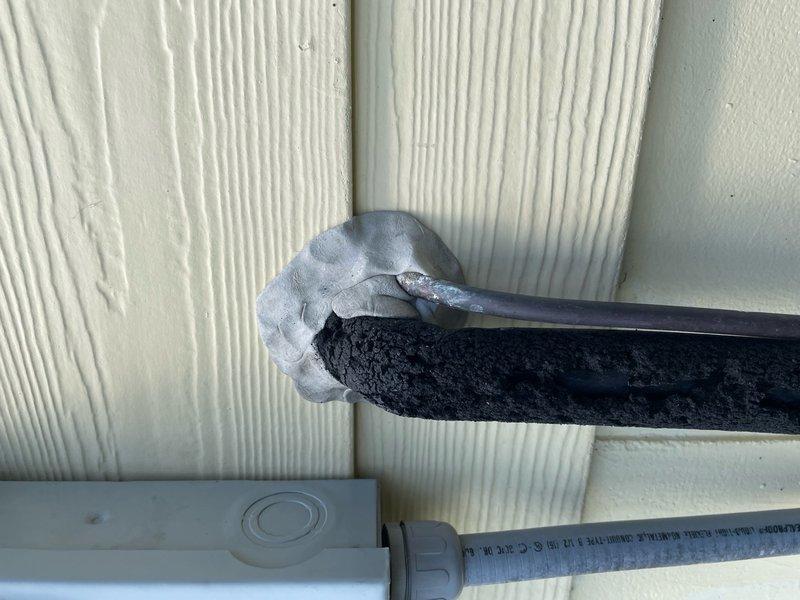 Completed callback for gaps around refrigerant lines entering structure. Inspected exterior and interior penetration points where linesets pass through wall from outdoor unit. Found inadequate sealing at wall penetration allowing air infiltration. Applied appropriate sealant and insulation materials to close gaps around both suction and liquid lines at entry point, ensuring proper weatherproofing and energy efficiency for 10-year-old system.