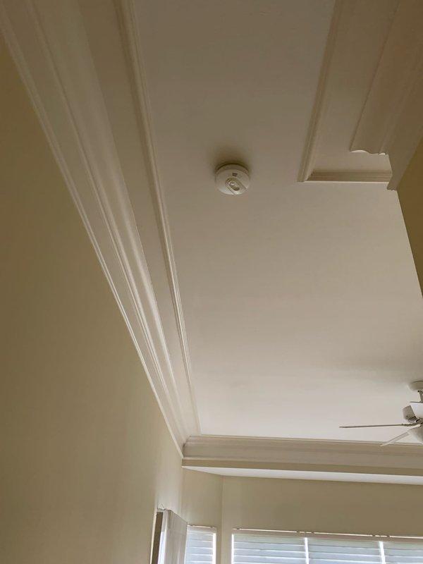 Installed hardwired smoke alarms throughout residence, replacing previous plug-in units that were no longer functional. Work included mounting devices to ceiling locations in multiple rooms including master bedroom area, ensuring proper electrical connections and testing all units for operational functionality.