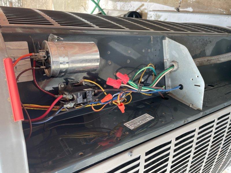 Completed scheduled cooling maintenance tune-up on outdoor HVAC unit. Performed comprehensive system inspection with top panel removed, verified all electrical connections including capacitor wiring and contactors, confirmed proper operation of all components, and system tested successfully with no issues found.