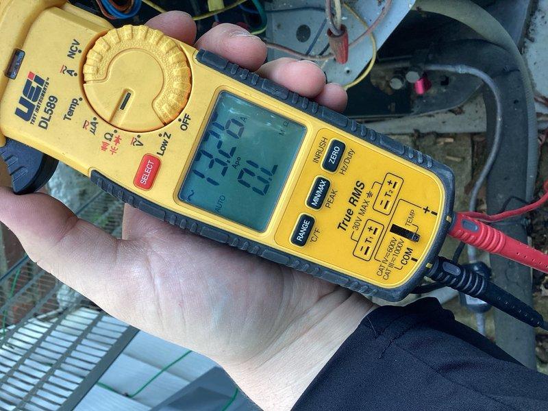 Completed scheduled cooling season tune-up on residential A/C unit located on side of home. Performed comprehensive system diagnostics including electrical testing of blower motor assembly and compressor components using digital multimeter and clamp meter to verify proper amperage draw and voltage readings. All measurements fell within manufacturer specifications at 294.5V and 34.4A. Inspected blower motor housing, fan assembly, and associated wiring connections. System operating normally with no deficiencies noted.
