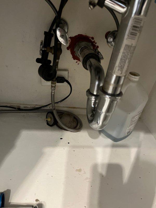 # Clogged Drain/Sink Resolution

Responded to reports of clogged drains affecting both the bathroom sink and dishwasher on the main floor. Upon inspection, identified blockage in the shared drainage system beneath the kitchen sink. Disassembled the P-trap assembly and related plumbing components to access and clear the obstruction. Removed accumulated debris and buildup from the trap and connecting pipes. Inspected the garbage disposal connection point and drain assembly for proper function and seal integrity. Reassembled all plumbing components, ensuring proper alignment and secure connections of the chrome P-trap, supply lines, and mounting hardware. Tested both the bathroom drain and dishwasher drainage to confirm full restoration of flow and proper operation. All fixtures returned to normal function with no leaks detected.