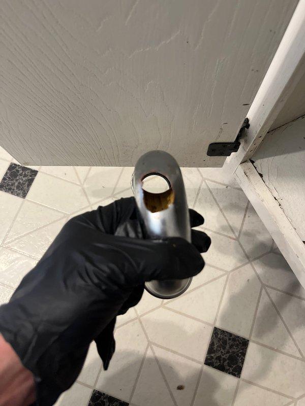 # Clogged Drain/Sink Resolution

Responded to reports of clogged drains affecting both the bathroom sink and dishwasher on the main floor. Upon inspection, identified blockage in the shared drainage system beneath the kitchen sink. Disassembled the P-trap assembly and related plumbing components to access and clear the obstruction. Removed accumulated debris and buildup from the trap and connecting pipes. Inspected the garbage disposal connection point and drain assembly for proper function and seal integrity. Reassembled all plumbing components, ensuring proper alignment and secure connections of the chrome P-trap, supply lines, and mounting hardware. Tested both the bathroom drain and dishwasher drainage to confirm full restoration of flow and proper operation. All fixtures returned to normal function with no leaks detected.