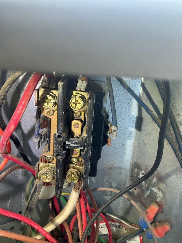 Completed preventive maintenance tune-up on outdoor condensing unit (O10 model) elevated on mounting brackets. Inspected and documented electrical connections at contactor and terminal block, verified all wire terminations secure with no signs of overheating, and confirmed proper equipment operation. All system components found in acceptable working condition with normal wear appropriate for unit age.