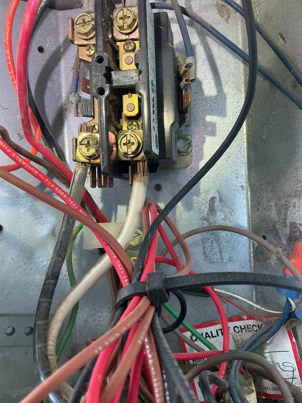 Completed preventive maintenance tune-up on outdoor condensing unit (O10 model) elevated on mounting brackets. Inspected and documented electrical connections at contactor and terminal block, verified all wire terminations secure with no signs of overheating, and confirmed proper equipment operation. All system components found in acceptable working condition with normal wear appropriate for unit age.