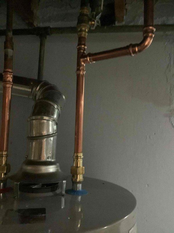 Successfully installed a 40-gallon gas tall water heater in the basement utility area with complete copper piping connections, pressure relief valve, and proper venting system. Installation included connecting hot and cold water lines with appropriate shut-off valves, securing the exhaust vent with proper elbow joints and clamps, and integrating the expansion tank into the plumbing system. All connections were tested for proper operation and the unit was verified to be functioning correctly per manufacturer specifications and local building code requirements for the City of University City.