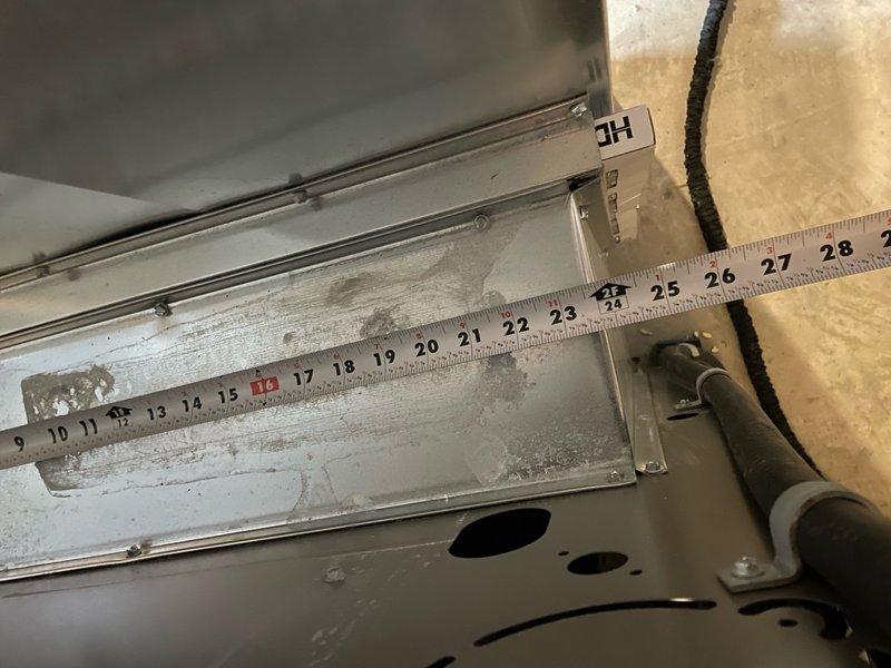 Responded to complaint of hot and humid conditions on upper level with possible short cycling and inadequate airflow from multiple supply vents. Inspected basement-mounted air handler unit, less than two years old. Measured condensate drain pan for proper drainage and verified unit model number M1 180UHF070336A-58. System evaluated for airflow distribution issues and cycling concerns to address comfort problems in conditioned space.