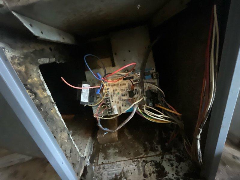 Completed scheduled tune-up and maintenance service on operational HVAC system over 10 years old. Inspected air handler unit interior, control board, and electrical connections; noted significant dust accumulation, deterioration of interior surfaces, and general wear consistent with system age. Documented existing insulation materials present at service location for reference.