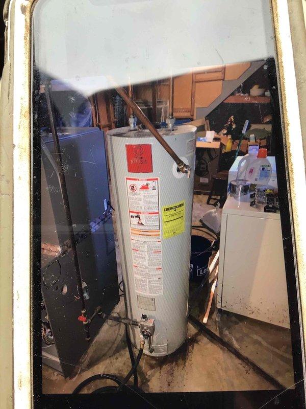 Installed a 40-gallon gas tall water heater in basement mechanical room. Connected copper supply lines and gas piping to new unit, installed pressure relief valve with discharge piping, and verified all connections for proper operation. Installation completed per local code requirements with no permit necessary per municipal regulations.