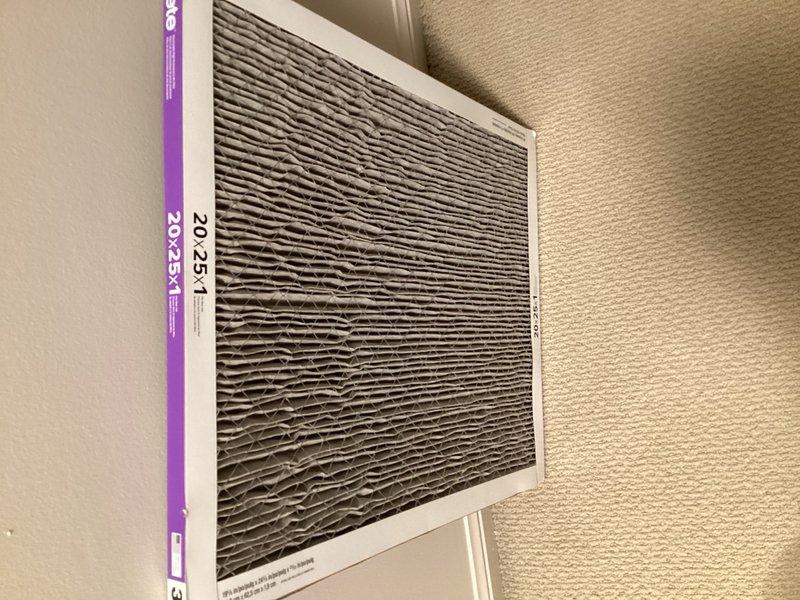 Responded to service call for 11-month-old upstairs attic unit experiencing noise when off and emitting musty odor. Upon inspection, found severely clogged 20x25x1 air filter with heavy dust and debris accumulation, restricting airflow and contributing to odor issue. Discovered significant condensation buildup on evaporator coil and interior ductwork, indicating inadequate airflow and potential drainage concerns. Replaced dirty air filter with new unit to restore proper airflow. Inspected condensate drain system and cleared minor blockage to ensure proper drainage. Cleaned evaporator coil surfaces to remove accumulated moisture and debris. Verified system operation after filter replacement, confirming reduced noise levels and improved air circulation. Advised homeowner on importance of regular filter changes every 30-60 days to prevent future airflow restrictions and maintain system efficiency. Unit operating normally at time of departure with proper airflow and no abnormal sounds dete