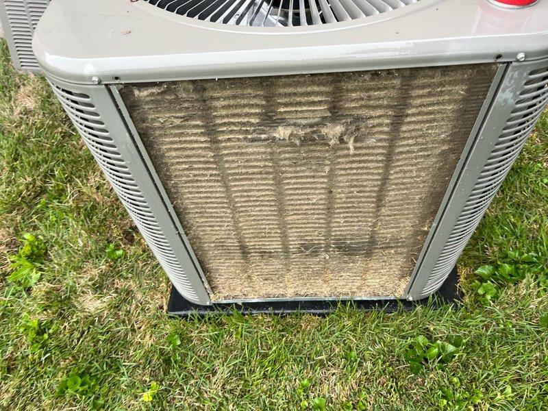 # No Cooling - Lennox AC Unit

Responded to no cooling call on 4-year-old Lennox air conditioning system. Upon arrival, confirmed unit was not operating. Conducted visual inspection of outdoor condenser unit and discovered severely clogged condenser coils with heavy accumulation of dirt, dust, and debris restricting airflow. Additionally found dirty air filter with significant particulate buildup affecting system performance.

Removed and cleaned condenser coils to restore proper heat exchange capacity. Replaced dirty air filter with new filter. Verified proper refrigerant line connections and electrical connections at outdoor unit. Cycled system on and confirmed unit now operating properly with adequate airflow across coils and proper cooling output. Advised ongoing maintenance schedule to prevent future airflow restrictions.