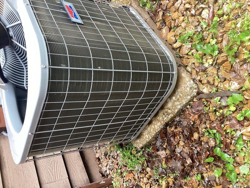 Completed comprehensive cooling system tune-up on outdoor condenser unit located in backyard. Performed full system inspection including electrical controls, circuit board connections, and relay components; cleared debris and vegetation from unit base and surrounding area; verified proper operation of fan assembly and protective grille. All components found to be functioning within normal parameters with no immediate repairs required.