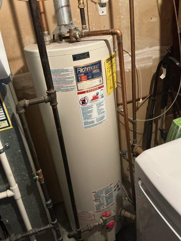 Installed a 40-gallon tall gas water heater in residential basement utility area. Connected copper supply and discharge piping to unit with appropriate shut-off valves and fittings, and installed metallic vent ducting for proper exhaust ventilation. Applied required plumbing identification sticker and completed installation per permit requirements.