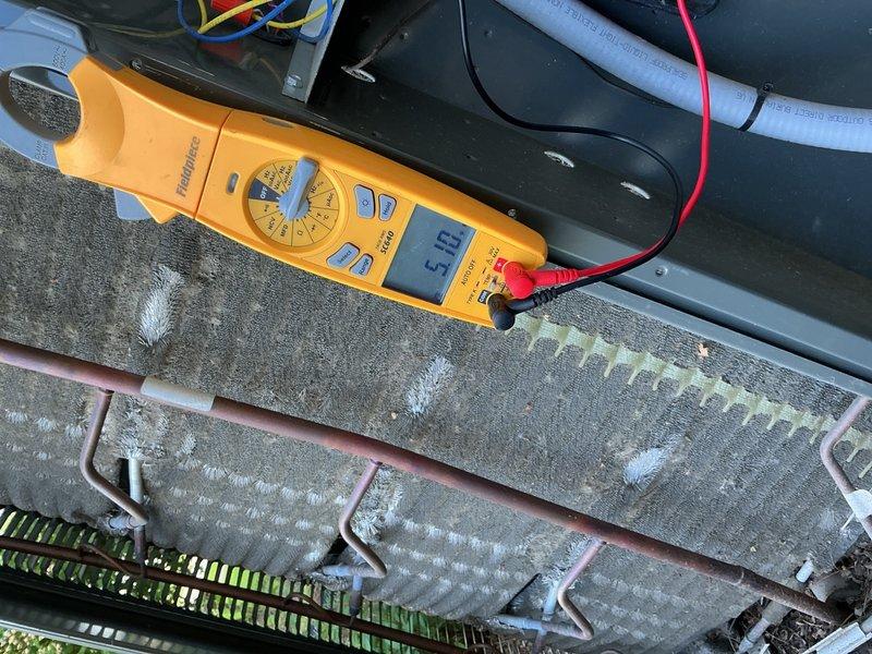 Completed comprehensive cooling maintenance and AC tune-up on a 9-year-old air conditioning system. Upon inspection, discovered significant dust accumulation on the blower wheel assembly and evaporator coils exhibiting extensive frost buildup. Performed electrical diagnostics using multimeter, recording amperage readings to verify system performance. Cleaned blower wheel blades and addressed refrigerant flow issues contributing to coil freezing condition. System tested and confirmed operational following service completion.