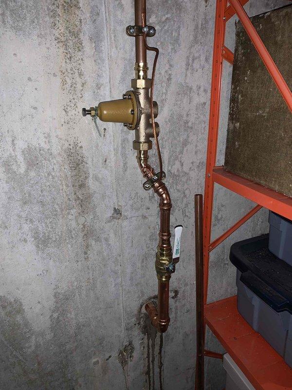 Completed full water service line replacement from meter to residence spanning approximately 50 feet. Coordinated excavation to expose existing deteriorated polyethylene water line, which showed severe corrosion and material degradation. Removed failed poly pipe in its entirety and installed new copper water service line with proper fittings and connections. Installed new interior shut-off valve assembly with brass fittings and pressure control components mounted to foundation wall. All connections pressure tested and verified for proper operation. Backfilled excavation upon completion of installation.