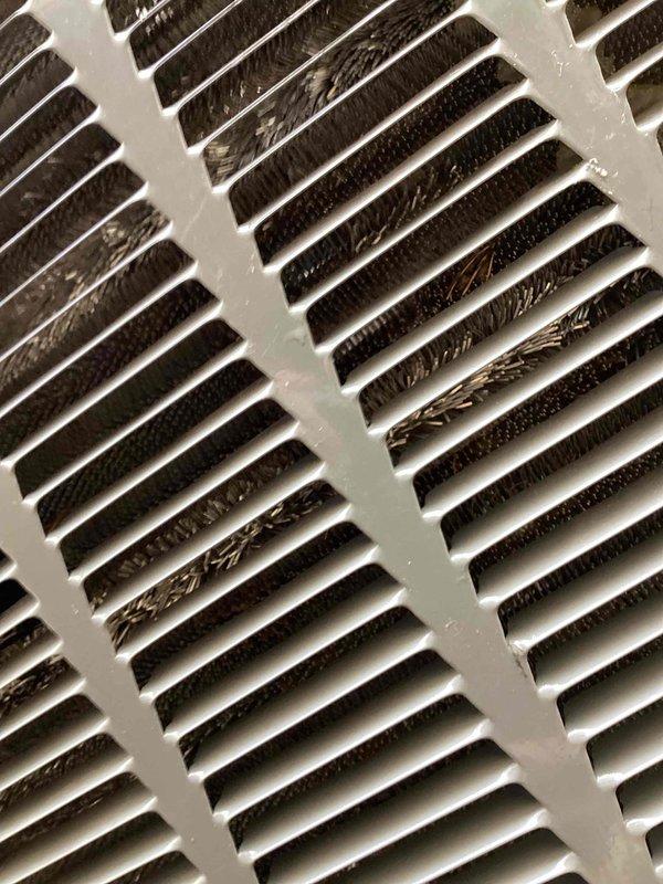 Completed seasonal cooling tune-up on 2-year-old Trane air conditioning system. Performed comprehensive inspection revealing significant dust and debris accumulation on evaporator coil fins and return air grille, which was restricting airflow and reducing system efficiency. Cleaned evaporator coil assembly, removing heavy buildup from aluminum fins and around copper refrigerant lines, then cleaned return air vent to restore proper air circulation. Verified refrigerant line insulation integrity, checked all electrical connections, and tested system operation to ensure optimal cooling performance.
