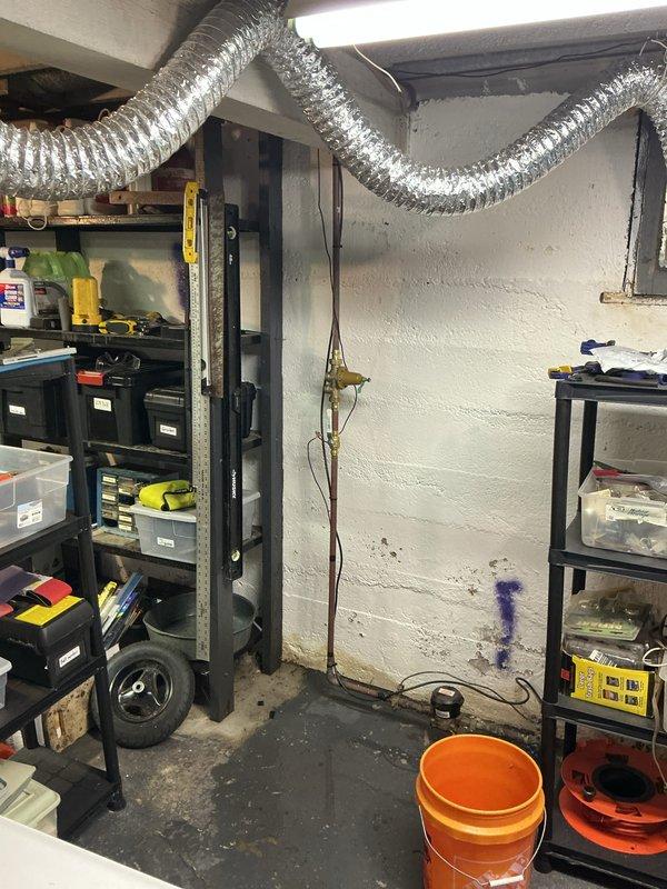 Installed a 40-gallon tall gas water heater in basement utility area with proper copper piping connections, expansion tank installation, and secure mounting. All connections were made to code specifications, with the blue expansion tank mounted horizontally and connected via copper piping to prevent thermal expansion issues. Installation completed in accordance with City of University City permit requirements, with all gas lines, water supply lines, and venting properly configured for safe operation.