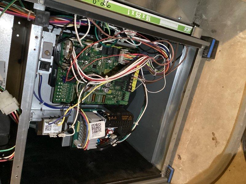 Completed preventive maintenance cooling inspection on a 9-year-old air conditioning system. Performed thorough examination of outdoor condenser unit, noting moderate debris accumulation on coil fins with visible streaking and dust buildup. Inspected electrical control panel and circuit boards, verifying all connections and wiring integrity across multiple control components. All system components found operational with no immediate service needs identified.
