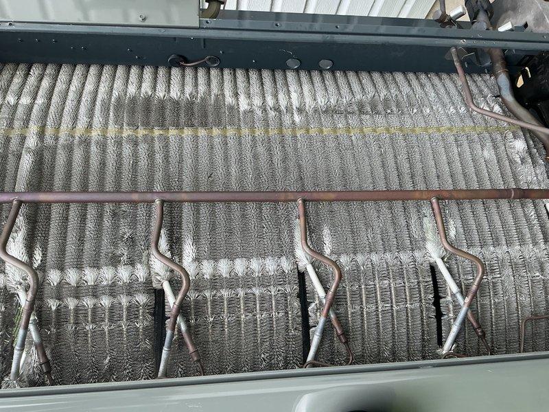 Completed scheduled cooling maintenance visit on residential HVAC system. Performed comprehensive inspection of evaporator coil assembly, confirming proper fin alignment and refrigerant line integrity with normal oxidation present on copper tubing. Replaced dirty air filter with accumulated debris, ensuring optimal airflow and system efficiency. System tested and operating within normal parameters upon completion.