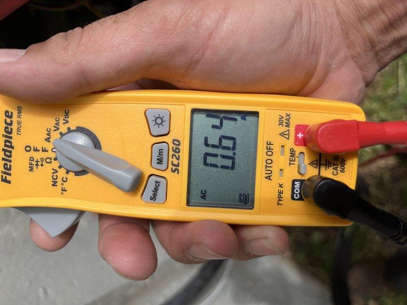 Responded to report of furnace making unusual noise. Performed comprehensive Cooling U10 maintenance inspection on 5-year-old unit located in basement. Conducted temperature diagnostics using digital thermometer, recording 71°F reading at ductwork/insulation area. Performed electrical testing with multimeter to verify system voltage and amperage readings, confirming proper electrical function at 0.5 reading. System operational with no abnormal noises detected at time of service.