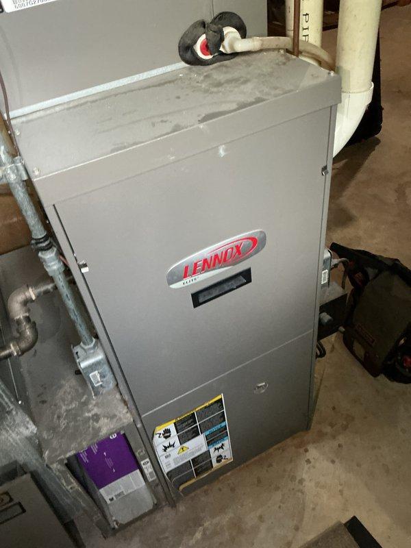 Completed comprehensive tune-up service on a single Lennox HVAC unit located at ground level on the side of the home. Performed standard maintenance procedures including inspection of all mechanical components, electrical connections, and refrigerant lines. Verified proper operation of the system and documented equipment condition through photographic documentation of both the indoor air handler unit in the basement utility area and exterior installation components where the unit interfaces with the building structure.