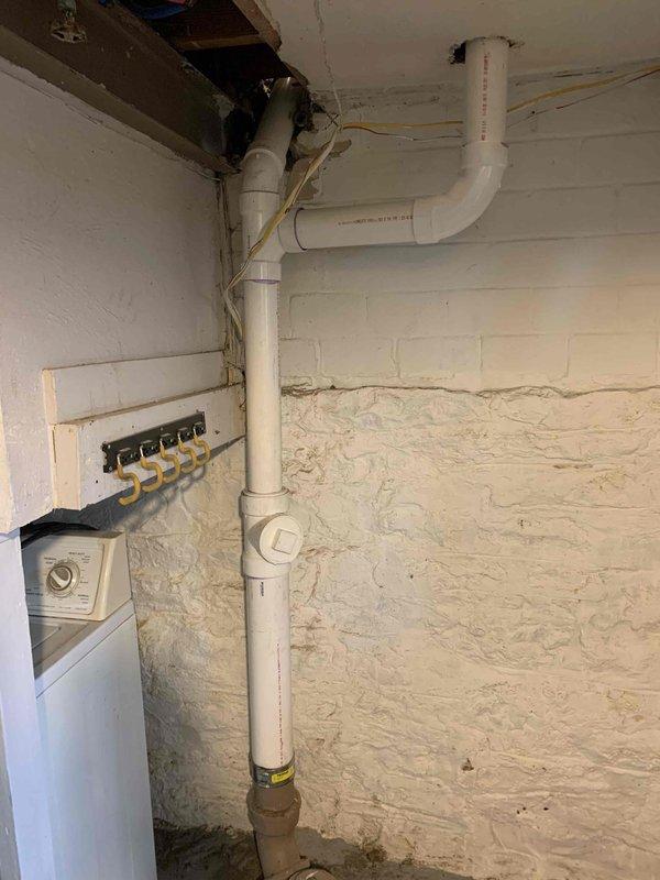 Removed existing cast iron drain piping, including the santee fitting for the lavatory drain connection. Replaced the removed cast iron section with new PVC piping, ensuring proper slope and secure connections. Installed new PVC fittings to accommodate the lavatory drain while maintaining code-compliant drainage system functionality.