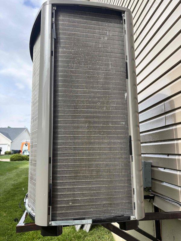 Completed comprehensive AC tune-up on single outdoor condenser unit as scheduled. Performed standard maintenance procedures including inspection of condenser coils which showed accumulation of dust, debris, and pollen on aluminum fins, system diagnostics, and documentation with photos. Unit is operational and accessible on exterior concrete pad.