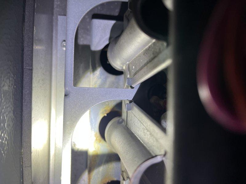 Responded to service call for 10-year-old Amana furnace located in basement with reported cracked heat exchanger identified during prior inspection. Performed thorough visual assessment and confirmed heat exchanger damage requiring replacement. Documented system condition with photographs showing furnace components, ductwork connections, and surrounding mechanical installations for warranty and repair planning purposes.