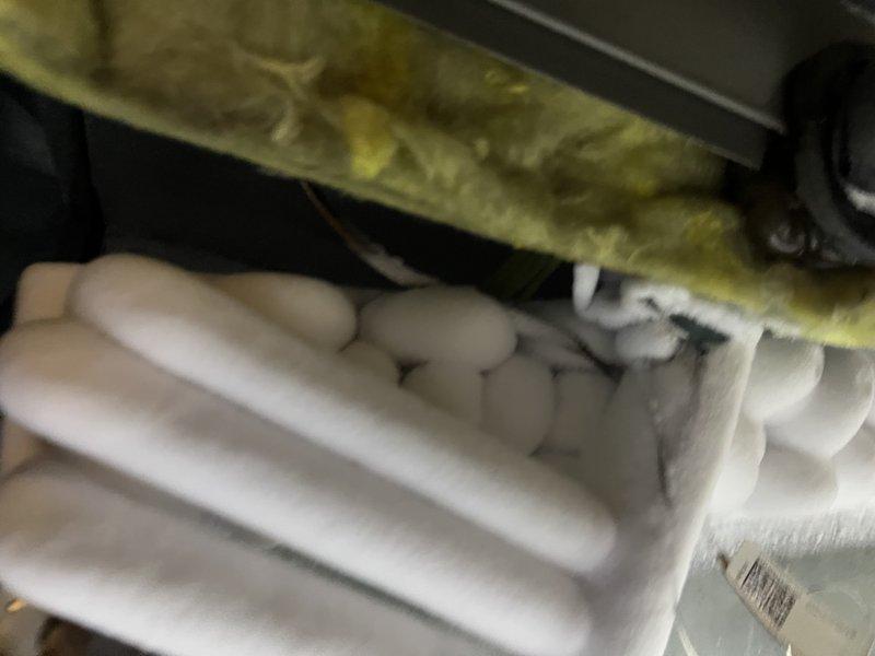 Responded to service call for non-operational Lennox system displaying error codes C2, A984, and E312. Upon inspection, discovered severe ice accumulation on the evaporator coil and refrigerant lines, indicating a complete system freeze-up. The ice buildup had formed thick, clustered formations along the suction line, preventing proper refrigerant flow and heat exchange. Identified compromised airflow as the primary cause, evidenced by displaced and deteriorated insulation around the air handler components. Assessed the 10-year-old system for underlying issues contributing to the freeze condition, including potential refrigerant charge problems, restricted airflow due to dirty filters or blocked return air, and possible thermostat or control board malfunctions triggering the error codes. Documented the frozen coil condition and insulation displacement with photographs for diagnostic reference. System required complete thawing before further diagnosis and repairs could be performed to r
